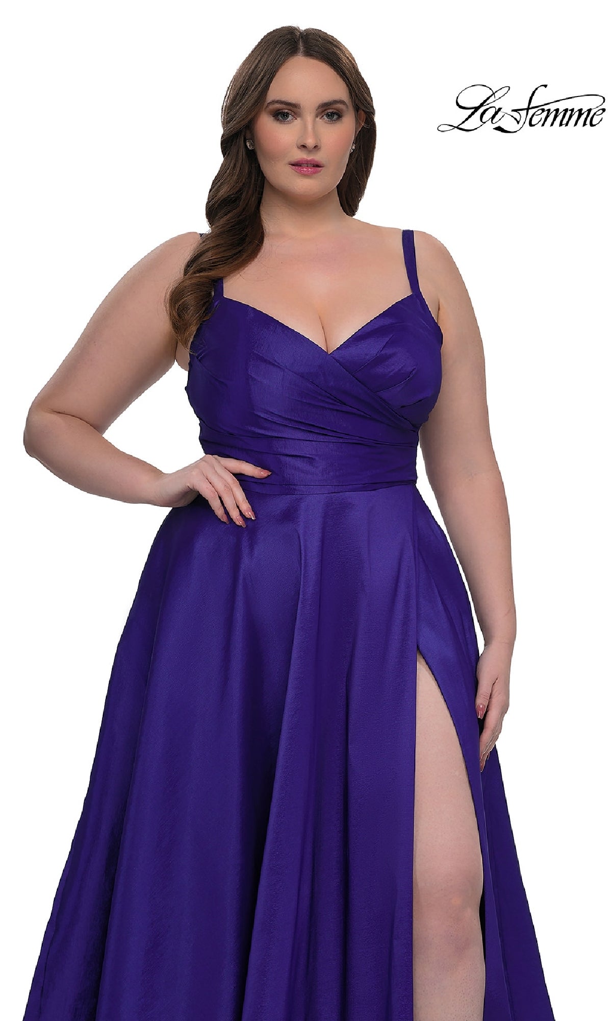 Model in the La Femme 33075 long plus-size prom dress: a sleeveless, deep purple gown with an A-line skirt and thigh-high slit, posed against a white background with